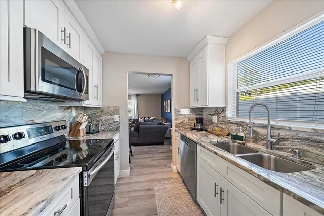 a kitchen with a stove microwave and sink