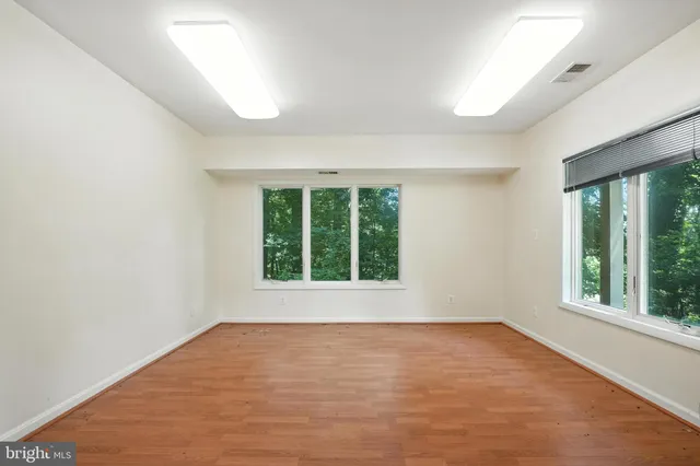 a bathroom with a granite countertop sink a mirror and a bathtub