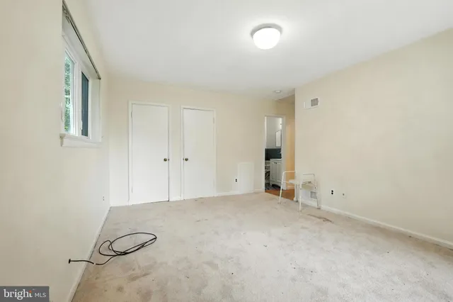 a view of an empty room with a window