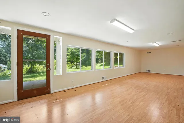 a view of a livingroom with an empty space and a window
