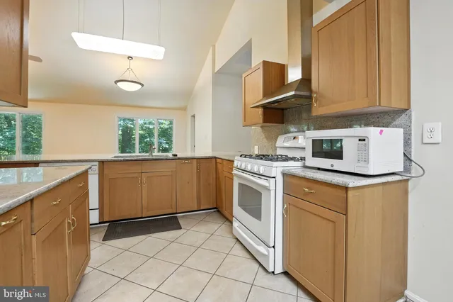 a kitchen that has a sink and a stove in it