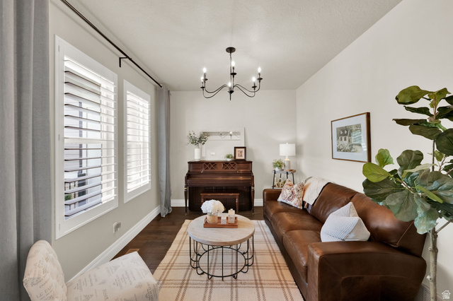 1132 South 1300th Street West Mapleton, UT 84664 - Photo 4 of 52 Living area featuring wood-finish flooring, light neutral wall tones, and white plantation shutters on dual windows