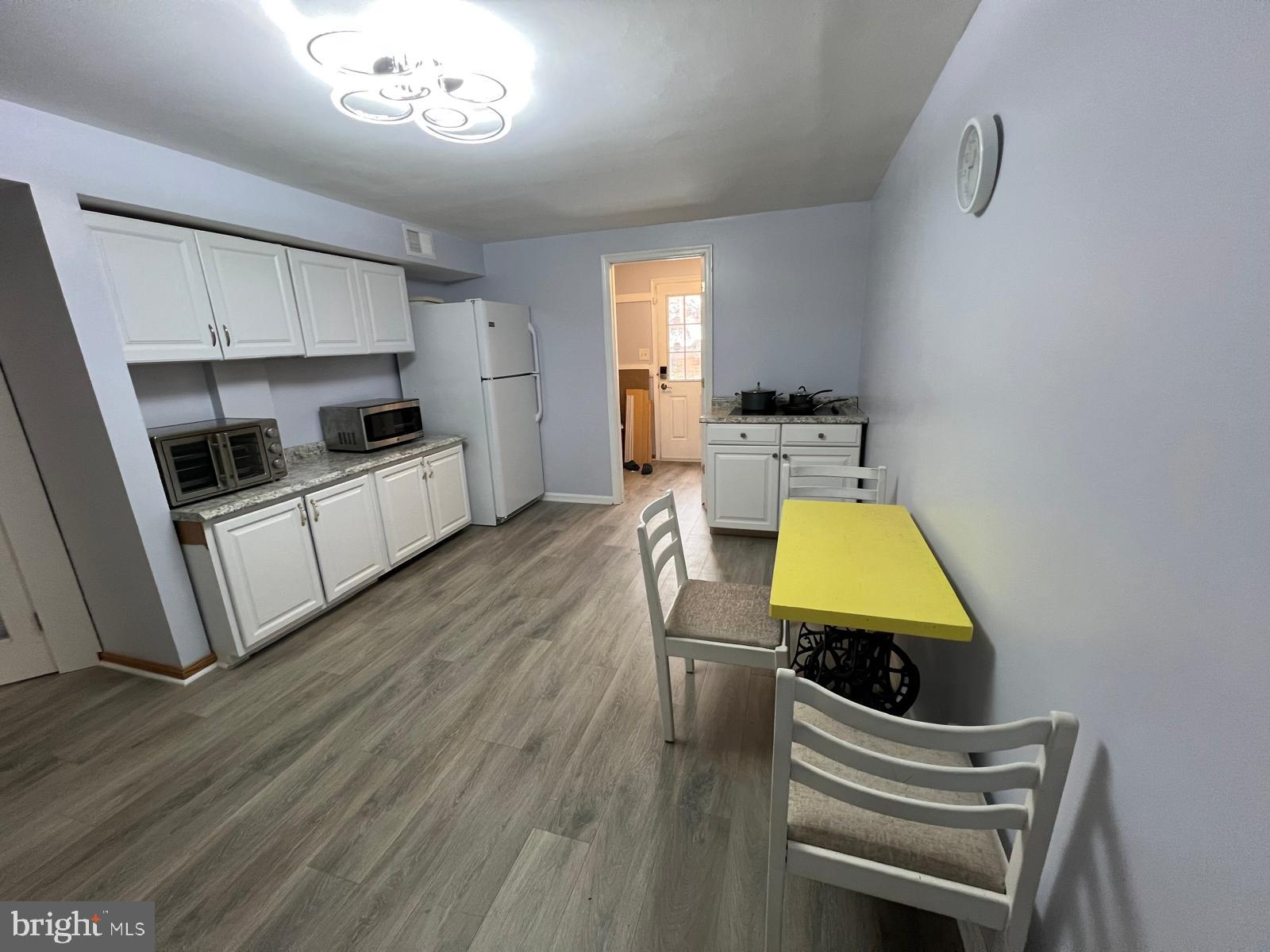 513 Creek Crossing Road Northeast Vienna, VA 22180 - Photo 14 of 15 a kitchen with microwave a stove and wooden floor