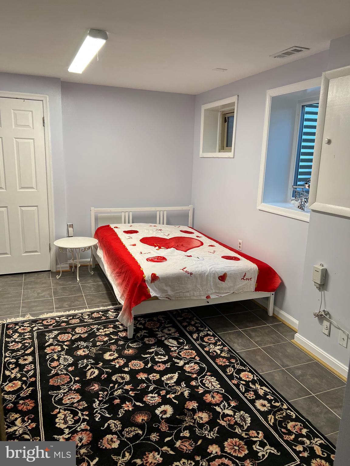 513 Creek Crossing Road Northeast Vienna, VA 22180 - Photo 3 of 15 a bedroom with a bed and a window