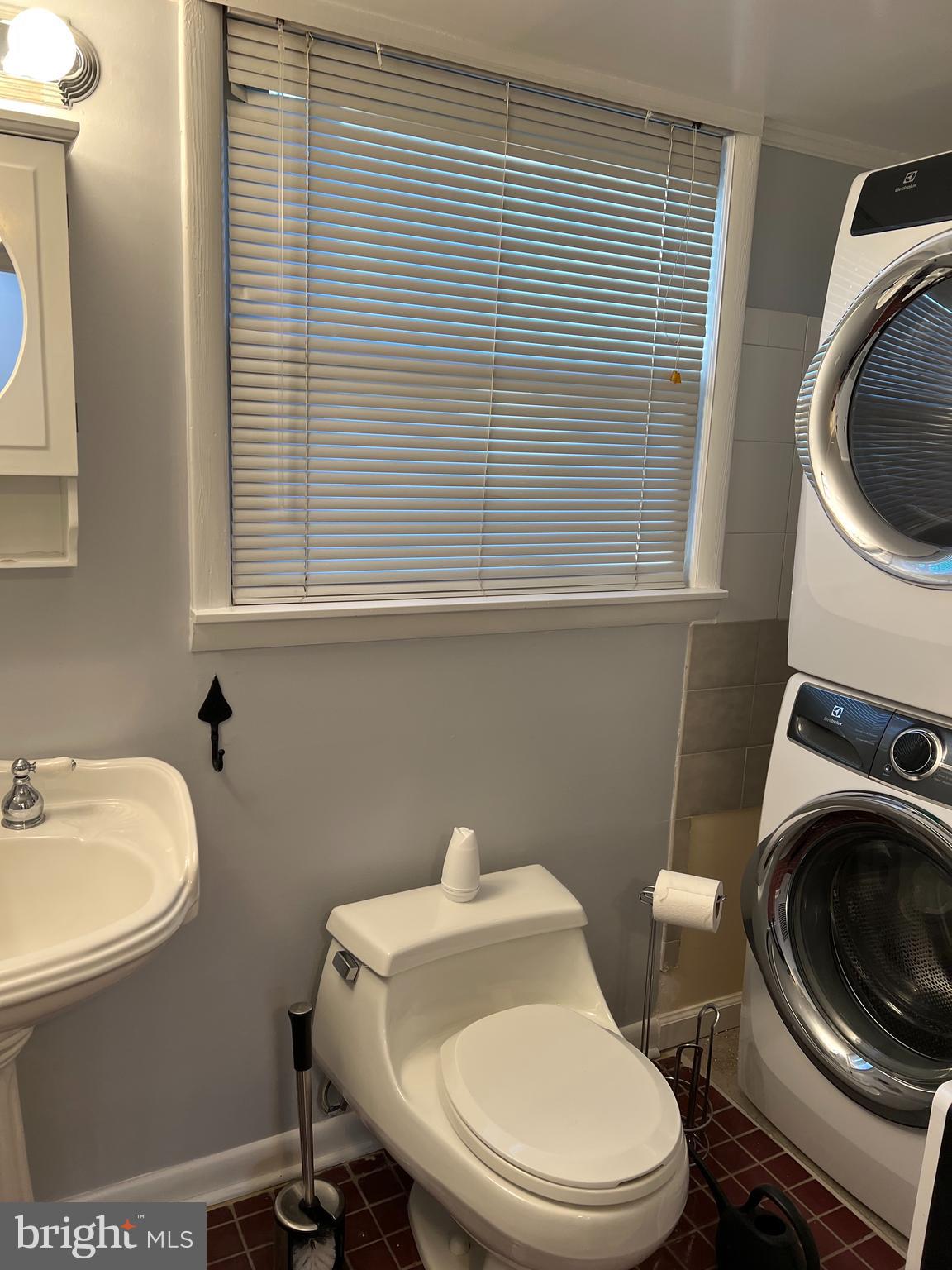 513 Creek Crossing Road Northeast Vienna, VA 22180 - Photo 5 of 15 a white toilet sitting next to a bathroom sink