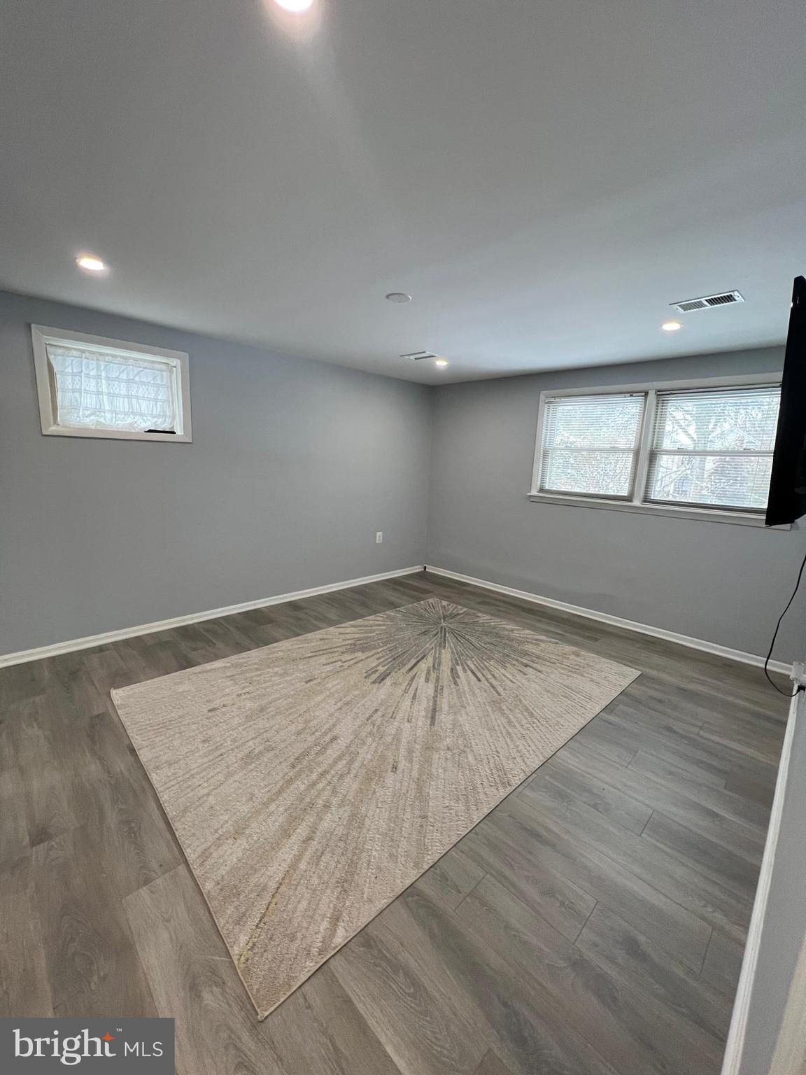 513 Creek Crossing Road Northeast Vienna, VA 22180 - Photo 9 of 15 an empty room with wooden floor and windows
