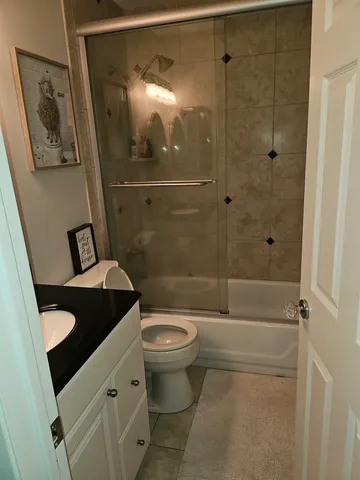 a bathroom with a toilet a sink and shower