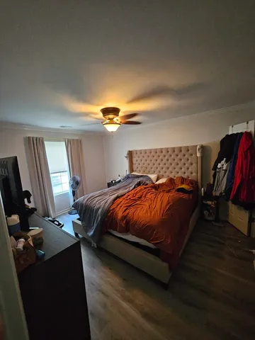 a bedroom with a bed and dresser