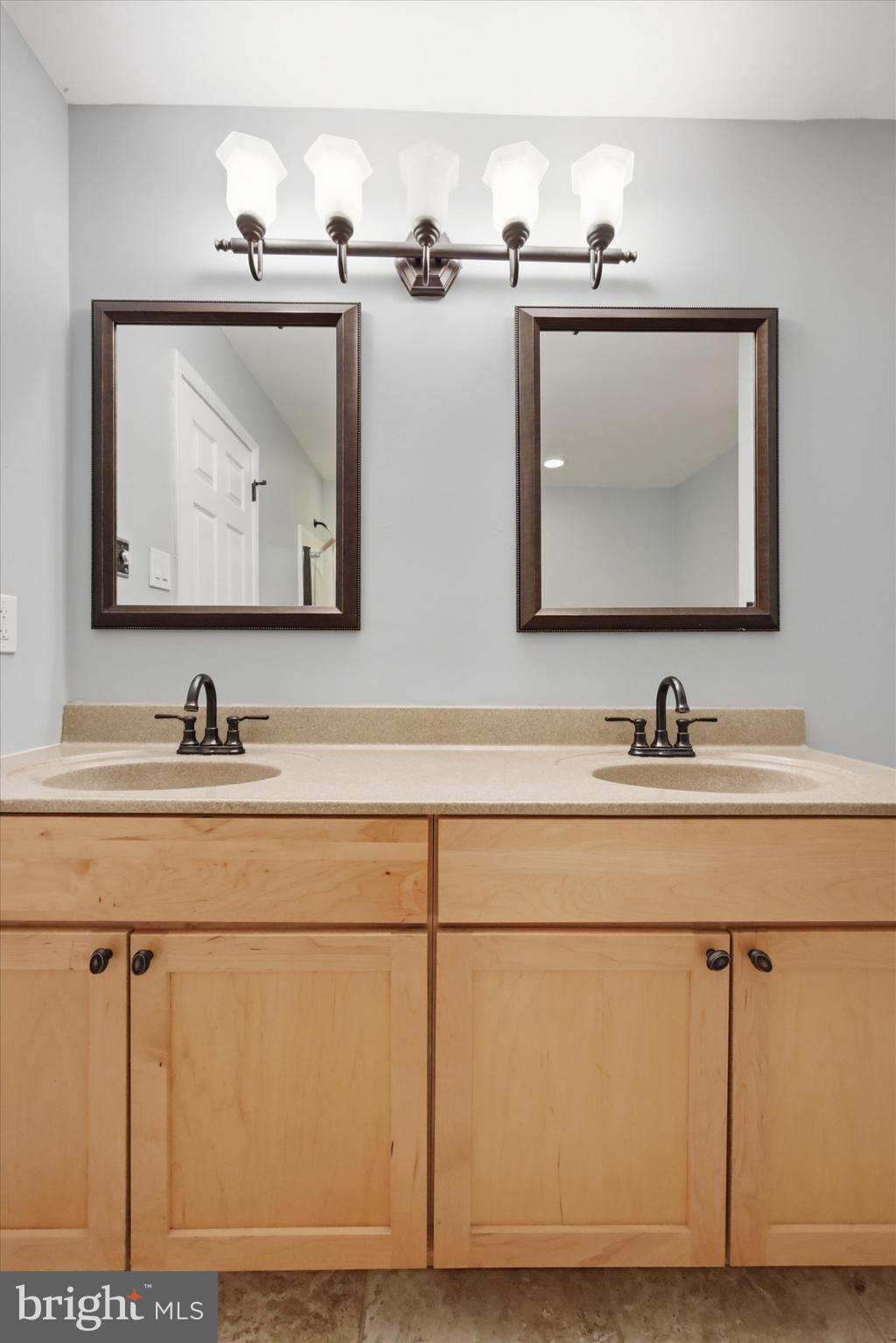 46 Main Street Chesterbrook, PA 19087 - Photo 24 of 44 a bathroom with a sink mirror and vanity