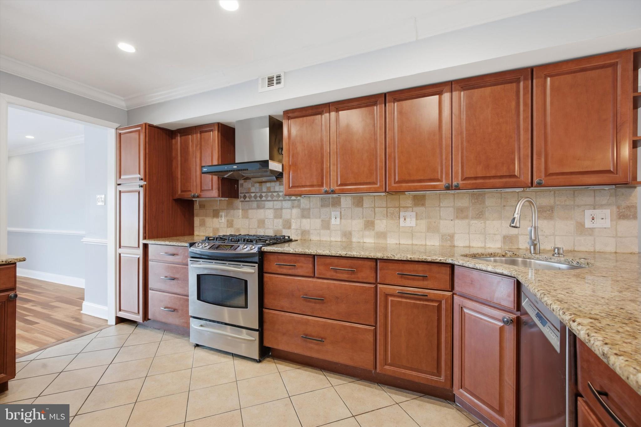 46 Main Street Chesterbrook, PA 19087 - Photo 8 of 44 a kitchen with stainless steel appliances granite countertop a stove a sink and a microwave