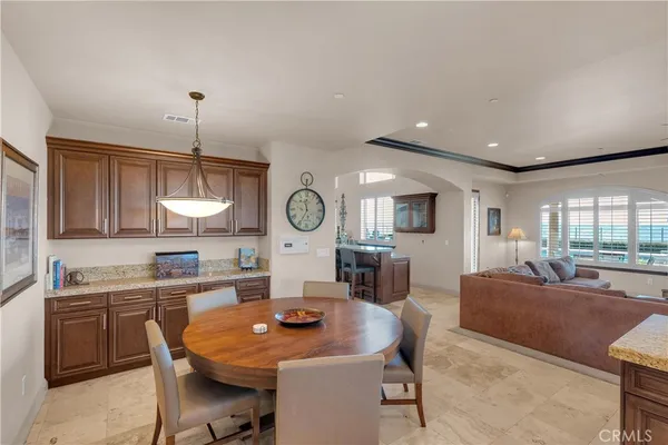 a kitchen with stainless steel appliances granite countertop a sink dishwasher a stove and a refrigerator with wooden floor