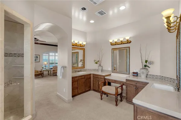 a bathroom with a granite countertop sink double and mirror