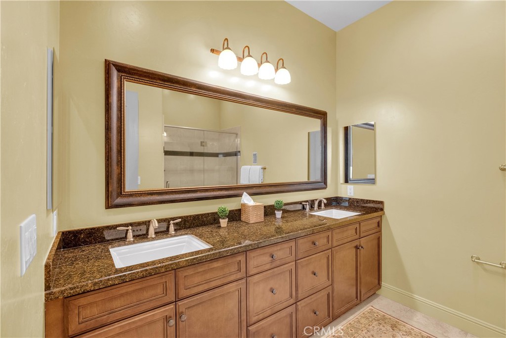 1990 East 46th Shandon, CA 93461 - Photo 29 of 70 a bathroom with a granite countertop sink double and mirror