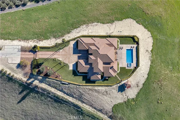 a view of a house with a swimming pool and a yard