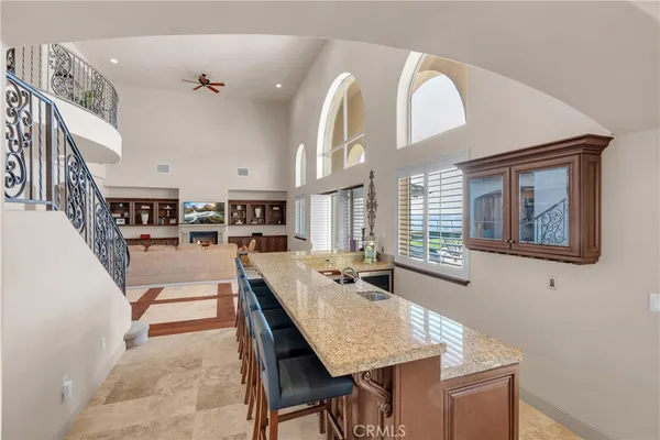 a large kitchen with kitchen island a sink a stove and a refrigerator