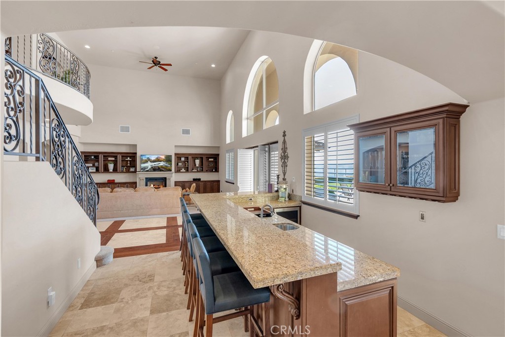 1990 East 46th Shandon, CA 93461 - Photo 10 of 70 a dining hall with stainless steel appliances kitchen island granite countertop a stove a dining table and chairs with wooden floor