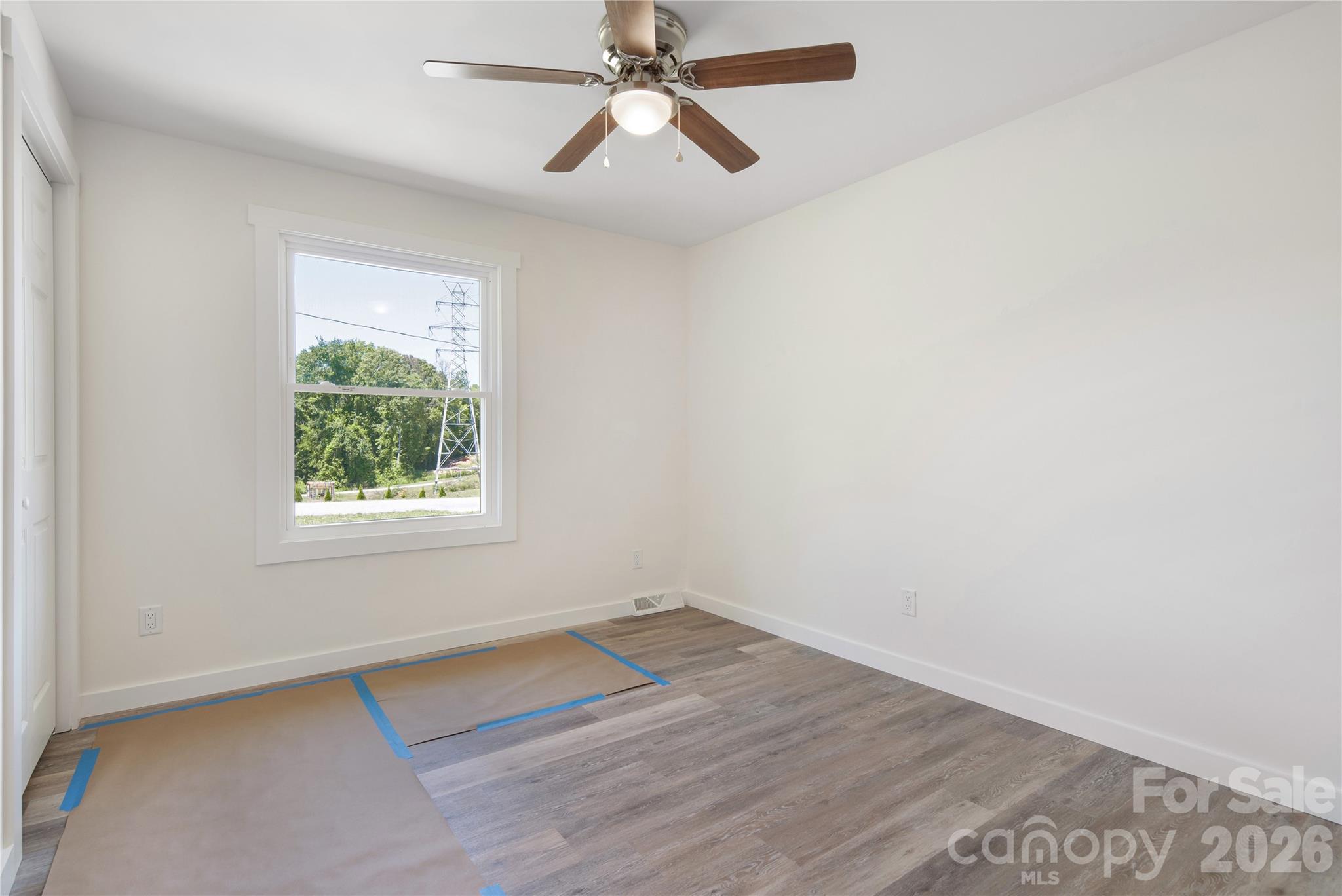287 Duncan Road Flat Rock, NC 28731 - Photo 12 of 13 an empty room with a window and a ceiling fan