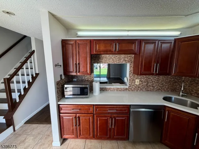 a kitchen with stainless steel appliances granite countertop a sink stove and cabinets