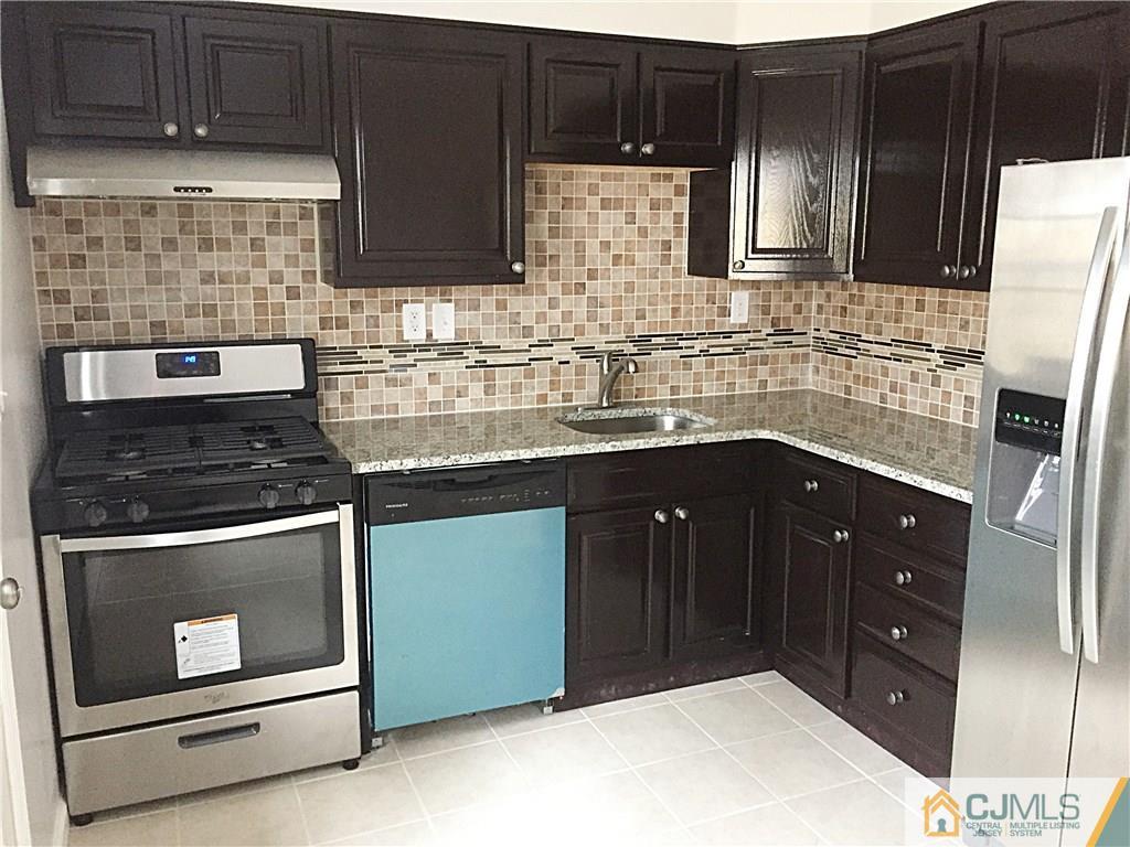 40 Parkerson Road Edison, NJ 08817 - Photo 3 of 11 a kitchen with stainless steel appliances granite countertop a stove a refrigerator and a sink