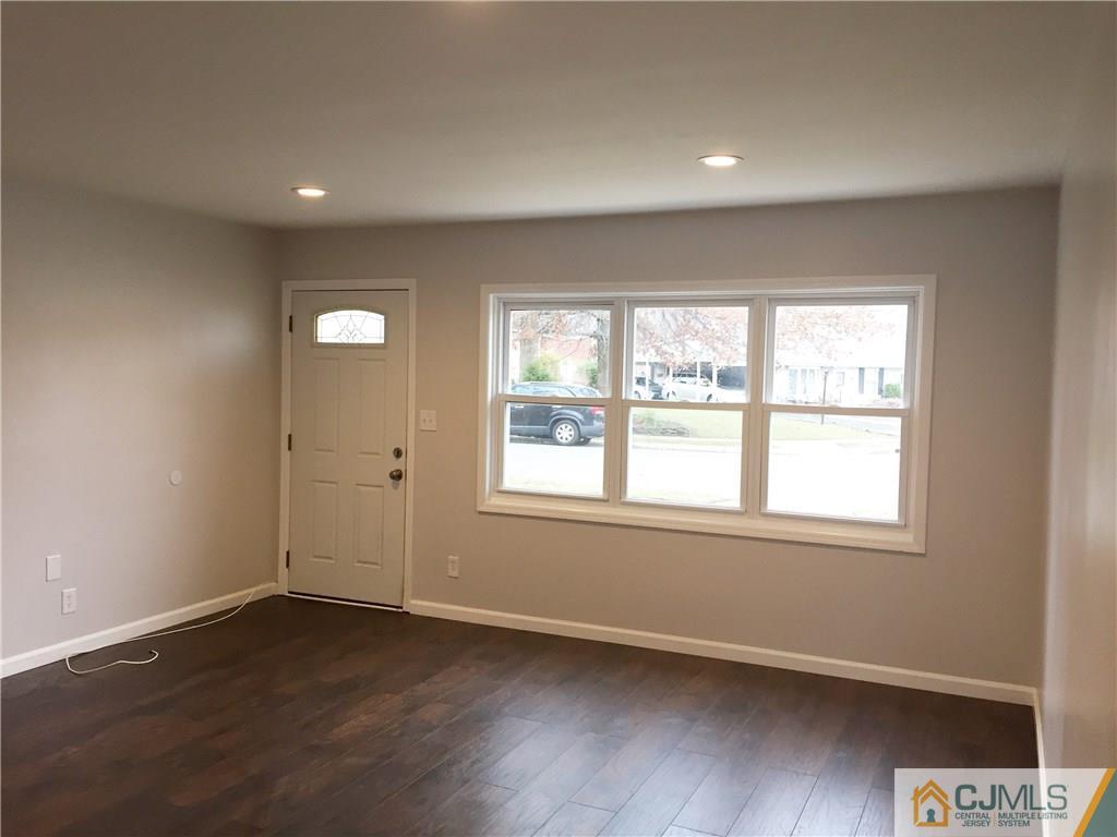 40 Parkerson Road Edison, NJ 08817 - Photo 5 of 11 an empty room with wooden floor and windows