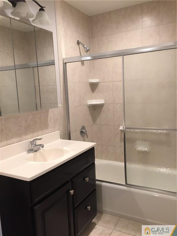 40 Parkerson Road Edison, NJ 08817 - Photo 7 of 11 a bathroom with a sink vanity mirror and shower