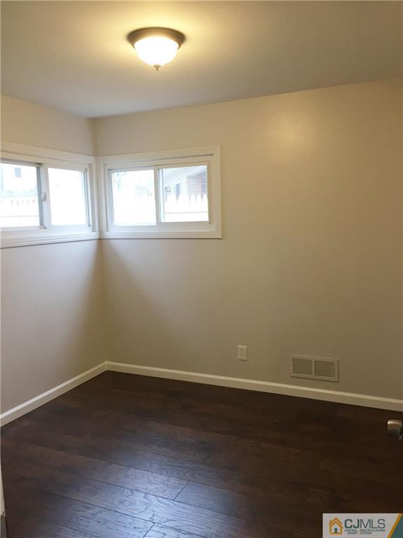 40 Parkerson Road Edison, NJ 08817 - Photo 9 of 11 a view of a room with wooden floor and windows in it