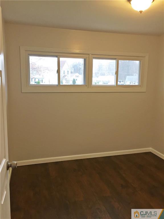 40 Parkerson Road Edison, NJ 08817 - Photo 10 of 11 a view of a small space with wooden floor and a window