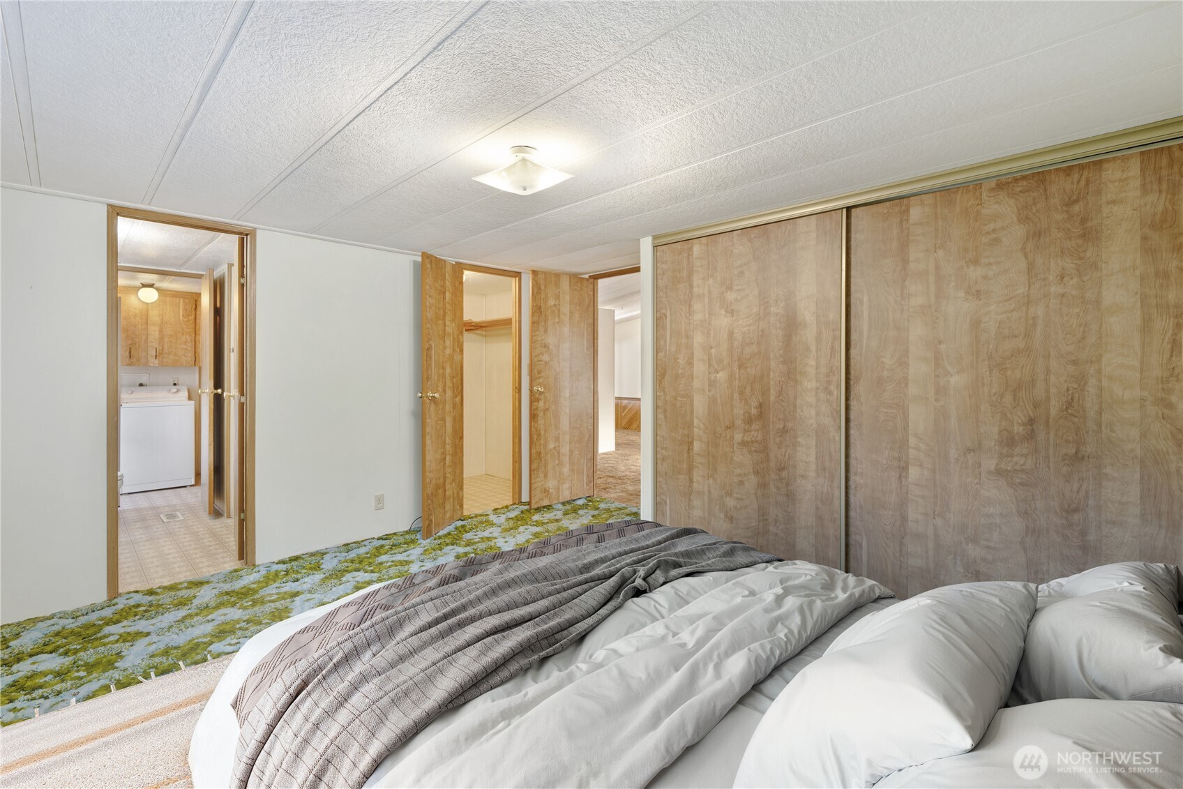4806 Cushman Road Northeast, Unit 139 Olympia, WA 98506 - Photo 11 of 22 a bedroom with a large bed and a large window