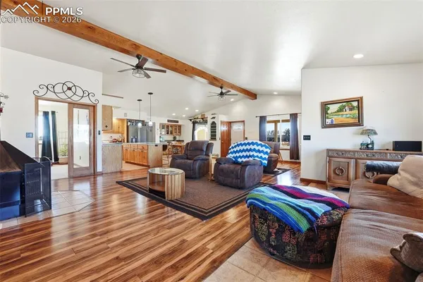 a living room with furniture a flat screen tv and a table