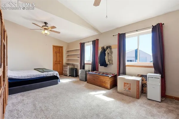 a bedroom with a bed furniture and a large window