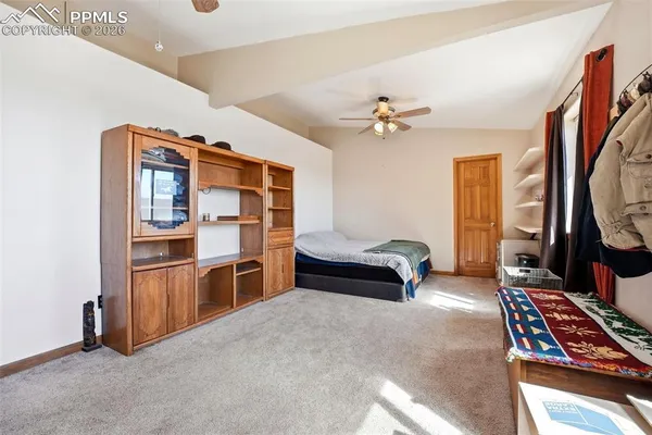 a bedroom with furniture and a window