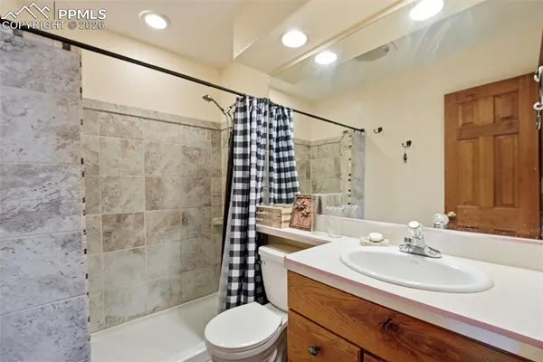a bathroom with a sink toilet and shower