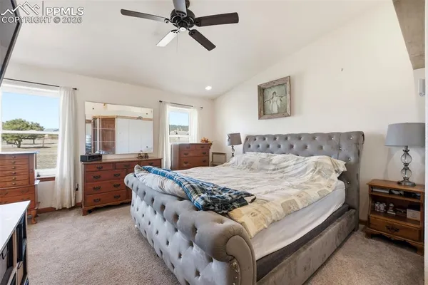 a spacious bedroom with a bed and furniture