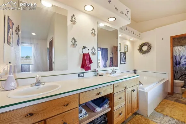 a bathroom with a tub sink and mirror