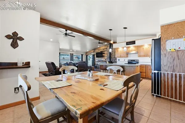 a dining room with furniture a rug and a chandelier