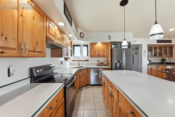 a kitchen with a sink a stove and cabinets