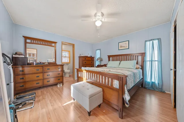 a bedroom with a bed and wooden floor