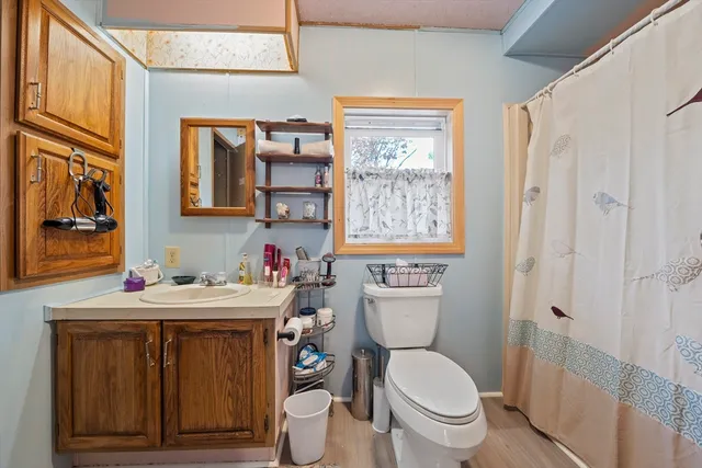 a bathroom with a toilet a sink and a window