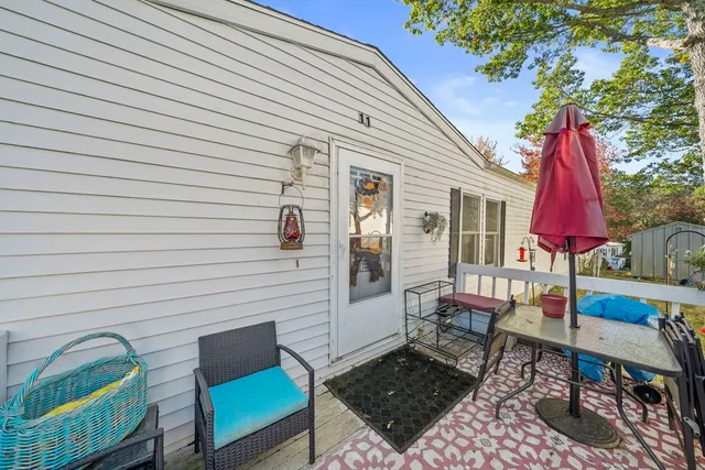 a view of a house with backyard and a tree