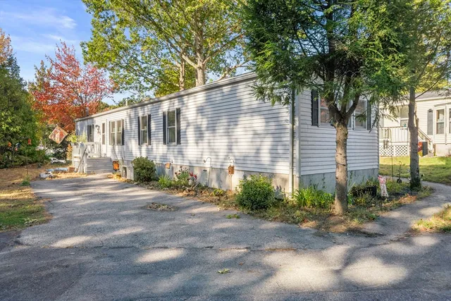 a view of a house with a yard and tree s
