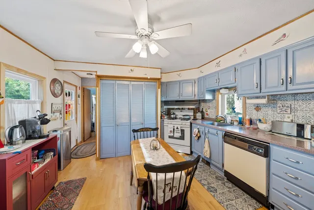 a kitchen with stainless steel appliances kitchen island granite countertop a refrigerator a stove top oven a sink and dishwasher