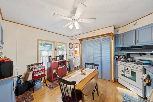 a open kitchen with stainless steel appliances granite countertop a stove refrigerator and cabinets