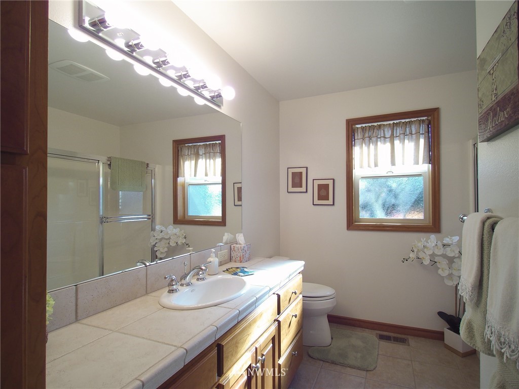 247 Jake Way Sequim, WA 98382 - Photo 18 of 40 a bathroom with a double vanity sink and a mirror