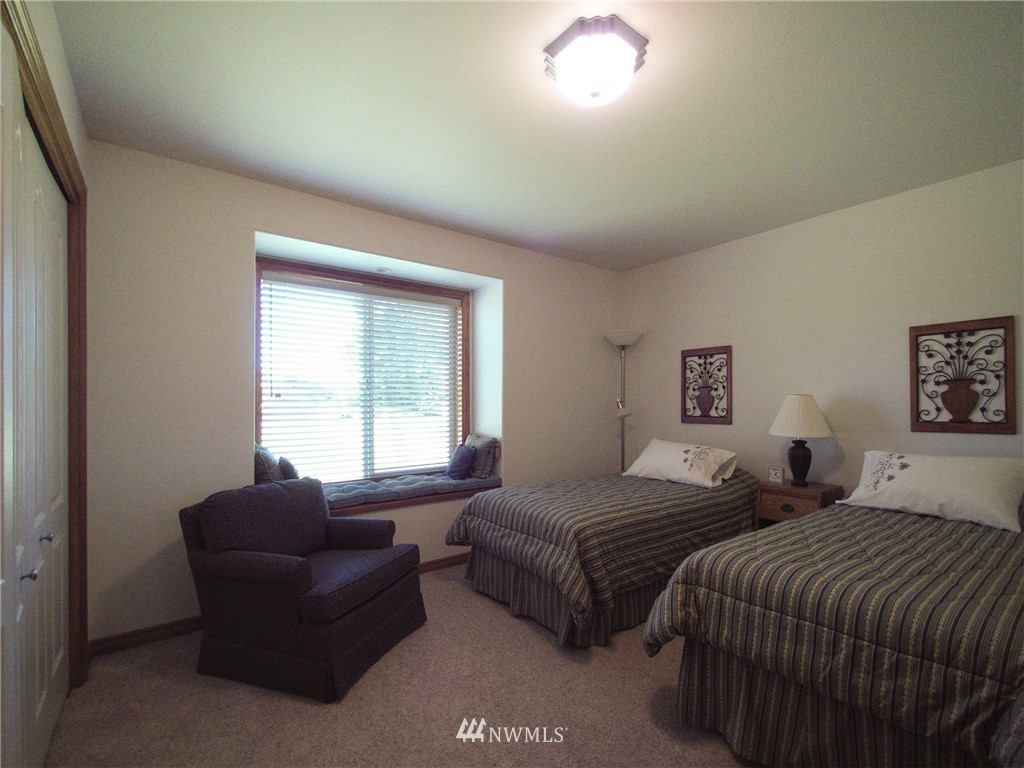 247 Jake Way Sequim, WA 98382 - Photo 19 of 40 a bedroom with two beds and a large window