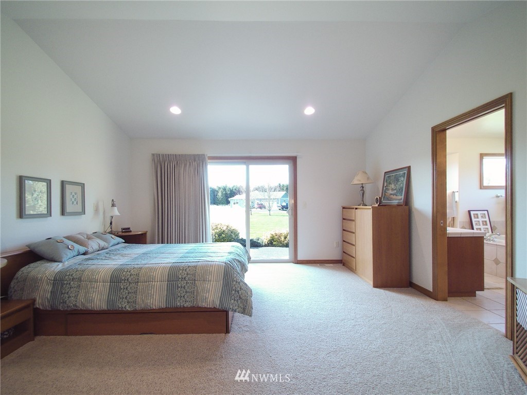 247 Jake Way Sequim, WA 98382 - Photo 23 of 40 a bedroom with a bed and a large window