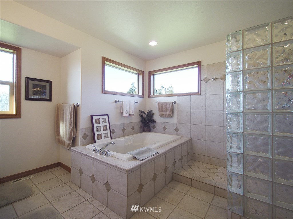 247 Jake Way Sequim, WA 98382 - Photo 24 of 40 a bathroom with a tub a sink and a mirror