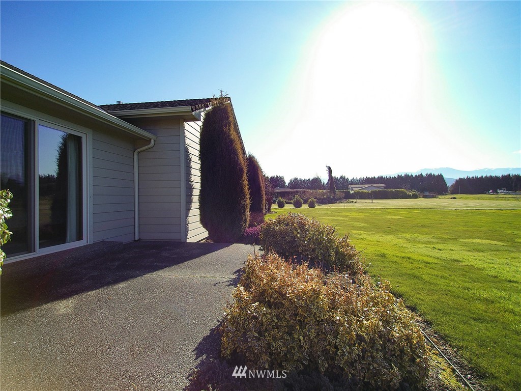 247 Jake Way Sequim, WA 98382 - Photo 29 of 40 a view of a backyard with plants and lake view