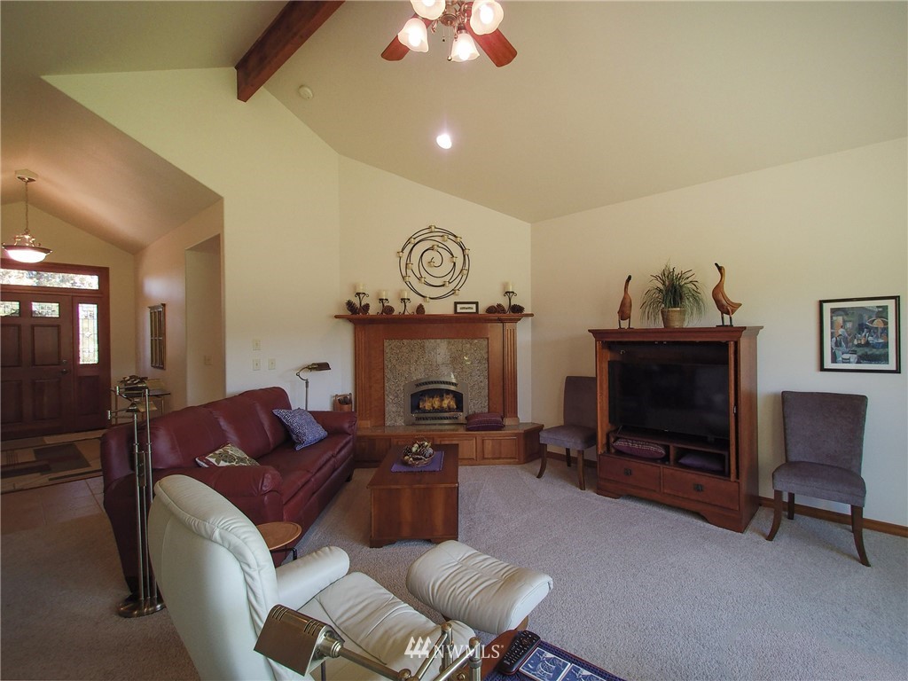 247 Jake Way Sequim, WA 98382 - Photo 4 of 40 a living room with furniture a fireplace and a chandelier