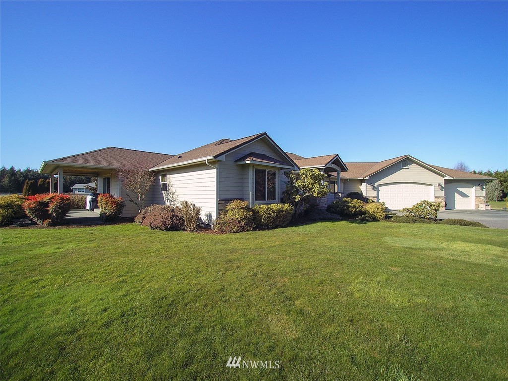 247 Jake Way Sequim, WA 98382 - Photo 35 of 40 a front view of a house with a garden