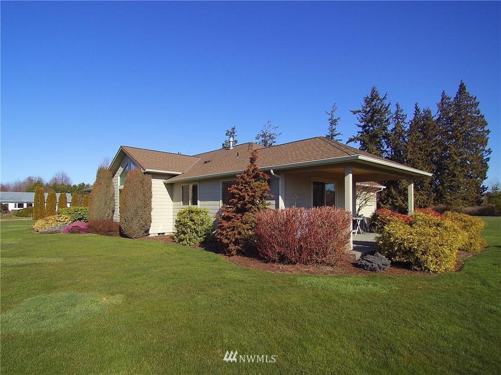 247 Jake Way Sequim, WA 98382 - Photo 36 of 40 a front view of a house with a garden
